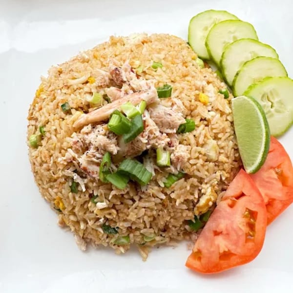 8thai restaurant's crab fried rice with green onions, lime, cucumber, and tomato slices.